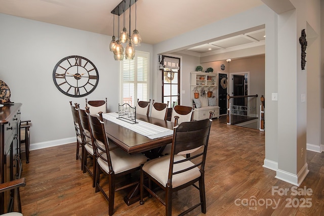 dining area featuring crown molding and dark hardwood / wood-style floors