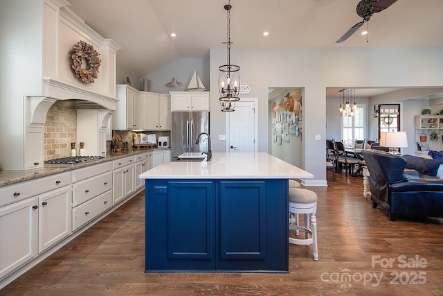 kitchen featuring pendant lighting, sink, a breakfast bar, appliances with stainless steel finishes, and an island with sink