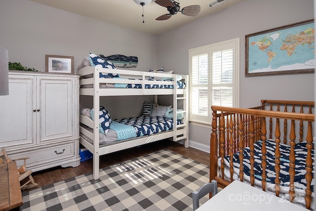 bedroom with dark hardwood / wood-style flooring and ceiling fan