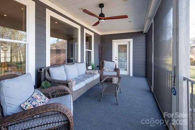 sunroom / solarium with wooden ceiling and ceiling fan