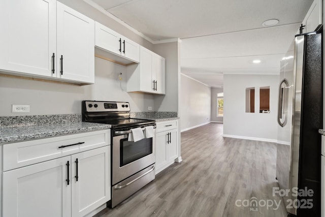 kitchen with light stone countertops, white cabinetry, appliances with stainless steel finishes, and ornamental molding