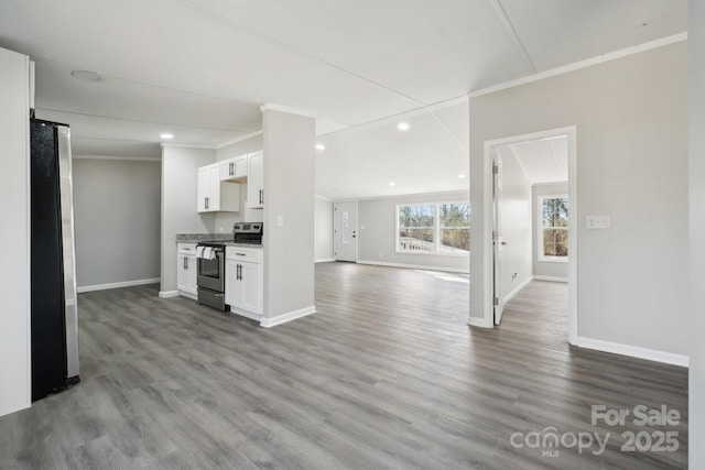 kitchen featuring white cabinetry, appliances with stainless steel finishes, crown molding, and wood-type flooring