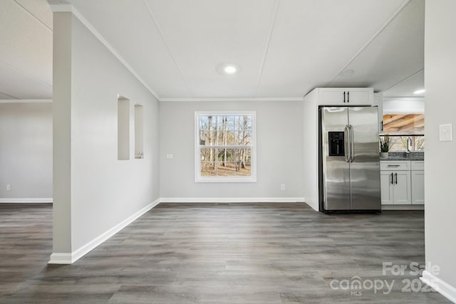 interior space with sink, dark wood-type flooring, and ornamental molding