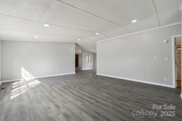 unfurnished living room with dark wood-type flooring and vaulted ceiling