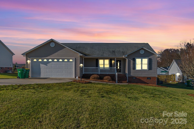 ranch-style home featuring a garage, a porch, and a yard