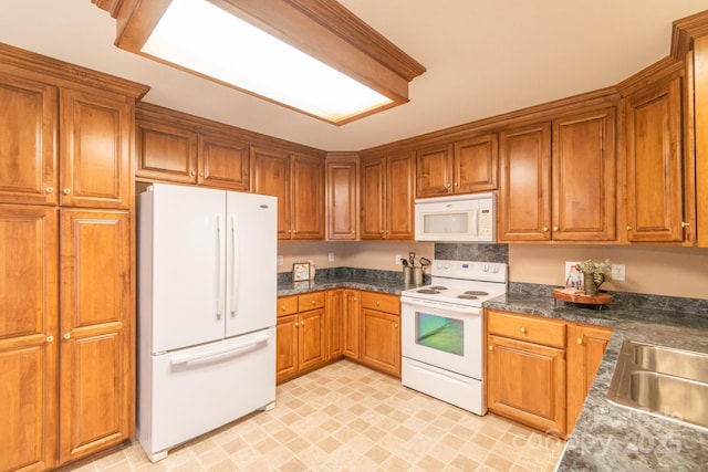 kitchen featuring sink and white appliances