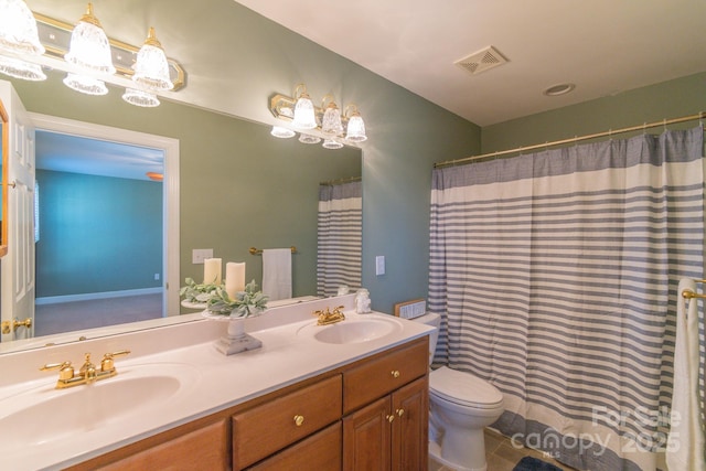 bathroom with vanity, toilet, and tile patterned flooring