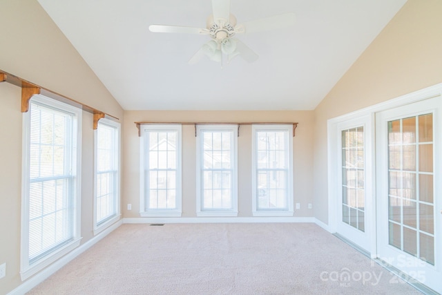 unfurnished sunroom featuring lofted ceiling, a wealth of natural light, and ceiling fan