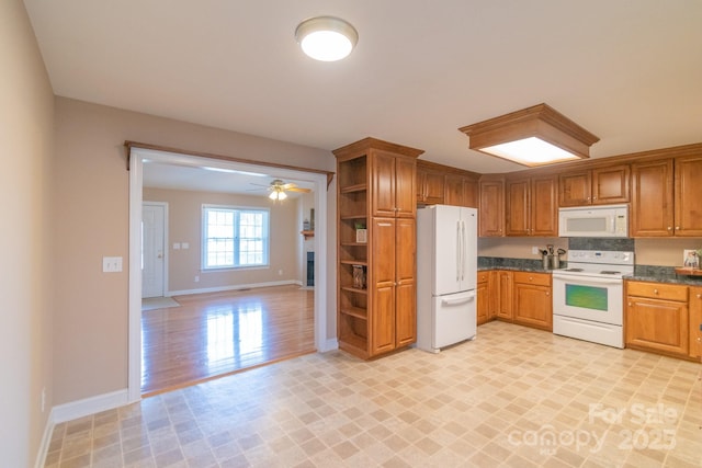 kitchen featuring brown cabinets, open shelves, dark countertops, white appliances, and baseboards