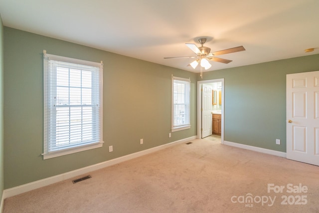 unfurnished bedroom with light carpet, baseboards, multiple windows, and visible vents