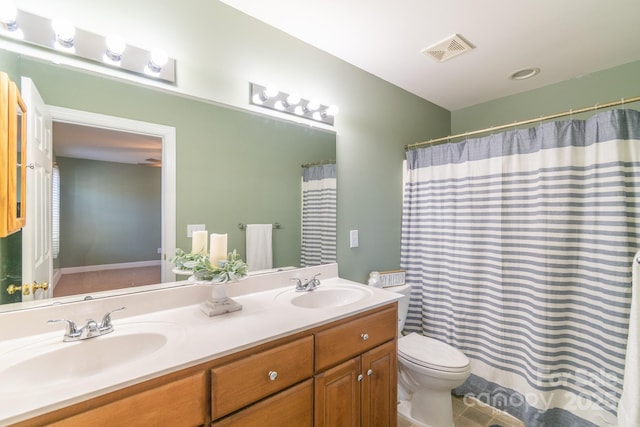 full bathroom featuring visible vents, a sink, toilet, and double vanity