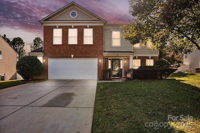 view of front of home featuring a garage and a yard