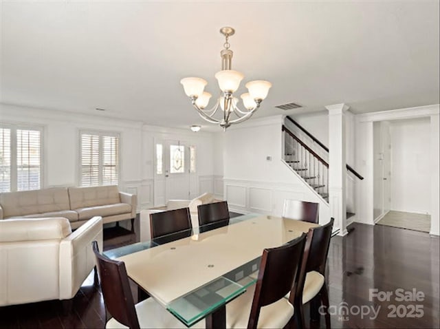 dining room featuring ornamental molding, dark hardwood / wood-style floors, and a chandelier