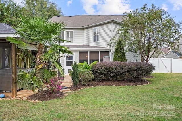 view of front facade featuring a sunroom and a front yard