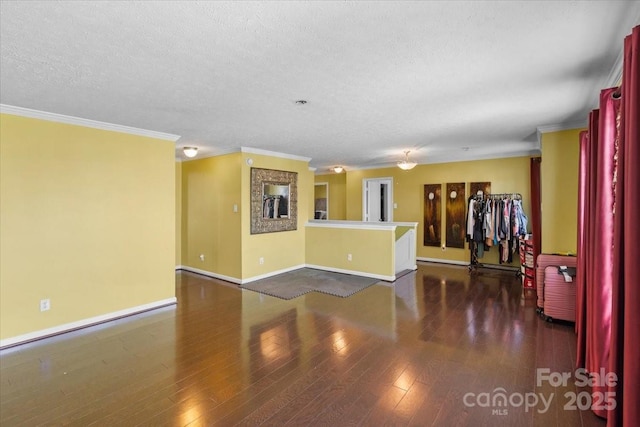 empty room with crown molding, dark hardwood / wood-style flooring, and a textured ceiling