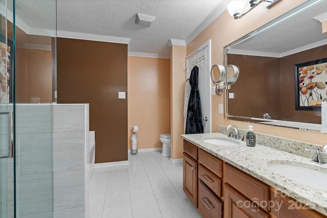 bathroom featuring vanity, ornamental molding, toilet, tile patterned floors, and a textured ceiling