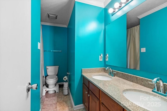 bathroom featuring vanity, crown molding, and toilet