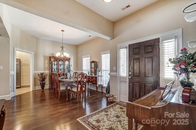 entrance foyer with dark wood-type flooring and a notable chandelier