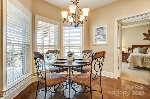 dining room featuring dark hardwood / wood-style floors and a chandelier