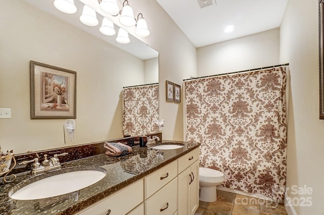 bathroom featuring walk in shower, vanity, and toilet