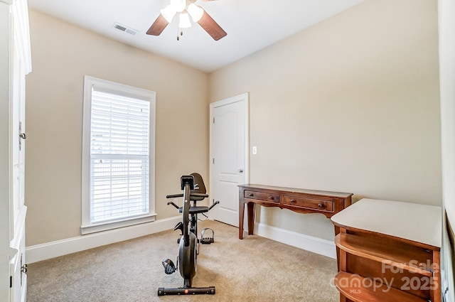 workout area featuring ceiling fan and light carpet