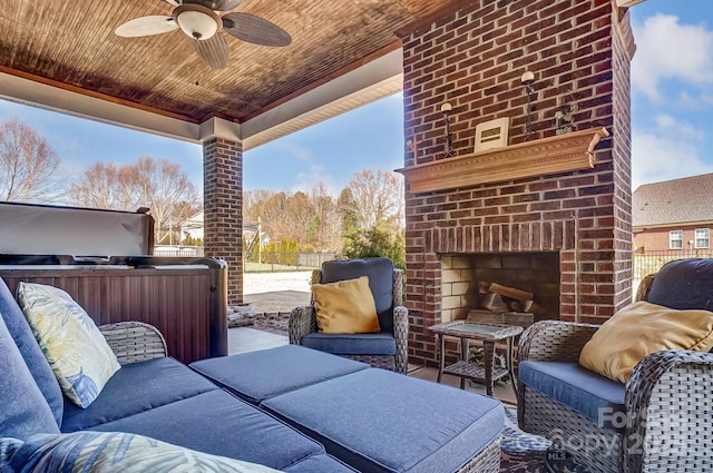 view of patio with an outdoor brick fireplace and ceiling fan