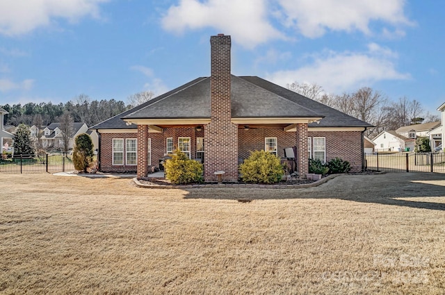 rear view of property with a lawn