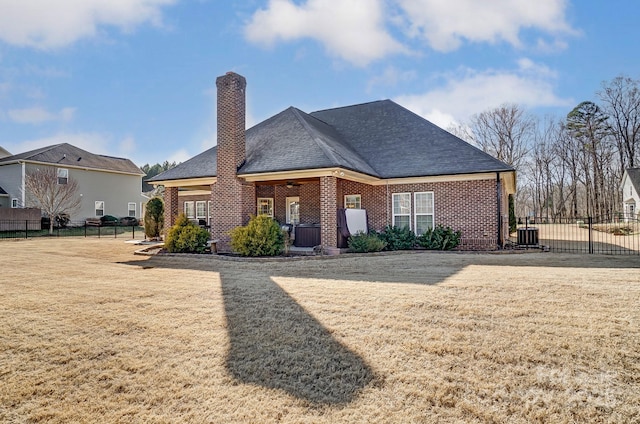 view of front of house featuring a front yard and central air condition unit