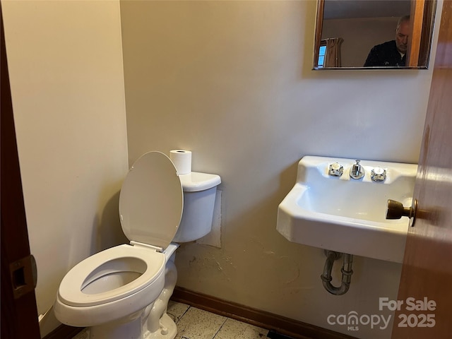 bathroom featuring sink and toilet