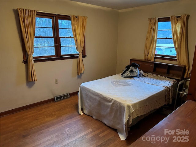 bedroom with wood-type flooring