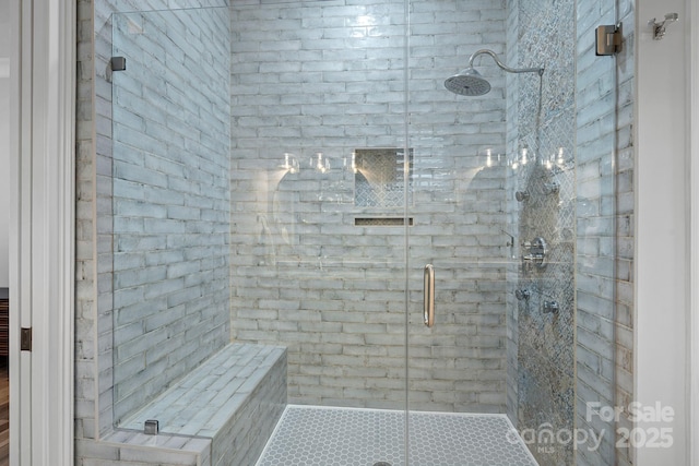 bathroom featuring a shower with shower door