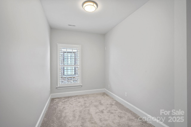 empty room with light colored carpet