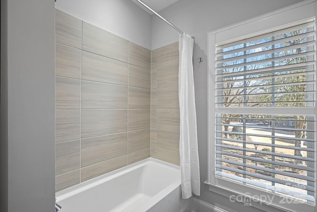 bathroom with shower / bathtub combination with curtain