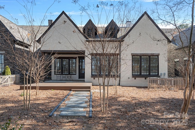 rear view of house featuring a wooden deck