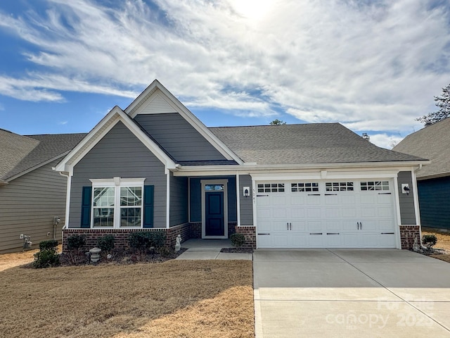 craftsman-style house with a garage and a front lawn