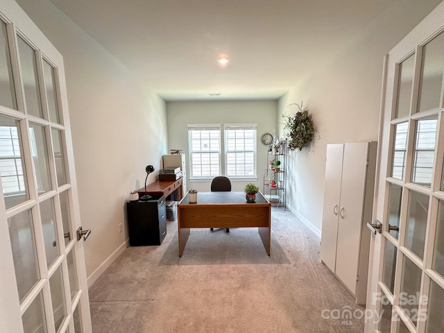 office with light carpet and french doors