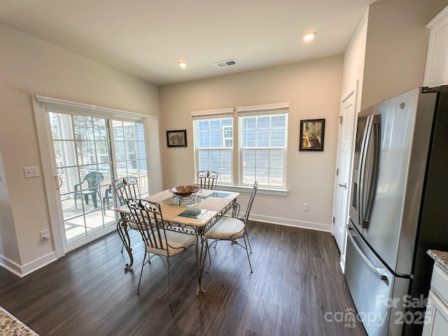 dining room featuring plenty of natural light and dark wood-type flooring