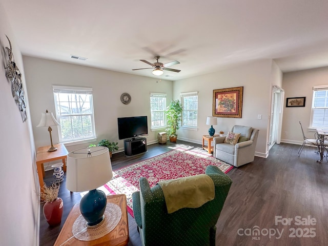 living room featuring dark hardwood / wood-style floors and ceiling fan