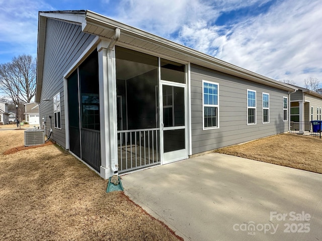 rear view of house with a patio area and central air condition unit