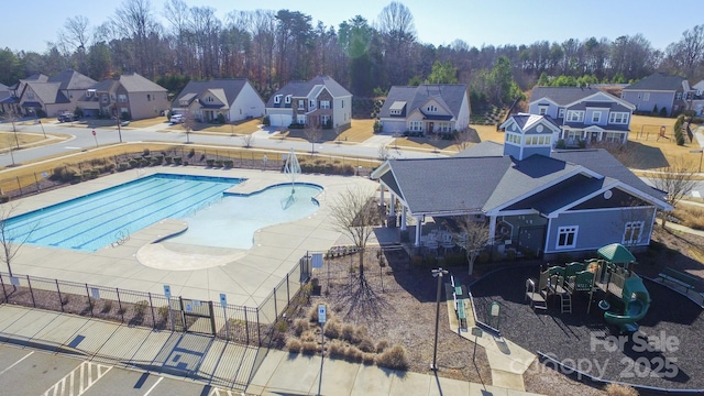 view of pool featuring a playground and a patio