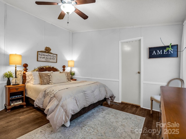 bedroom featuring ceiling fan, ornamental molding, and dark hardwood / wood-style floors