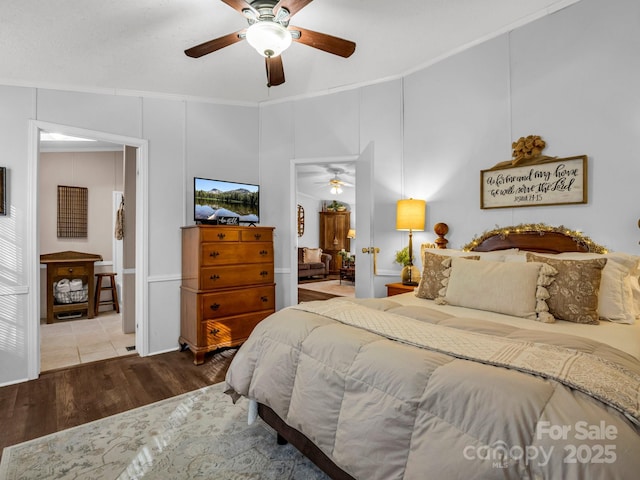 bedroom with ornamental molding, hardwood / wood-style floors, and ceiling fan