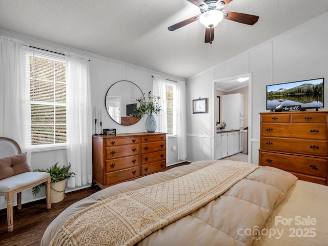 bedroom with lofted ceiling, crown molding, a textured ceiling, dark hardwood / wood-style flooring, and ceiling fan