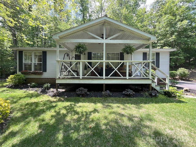 243 Buffalo Creek Rd, Lake Lure, NC 28746 - back of house featuring a porch and a yard