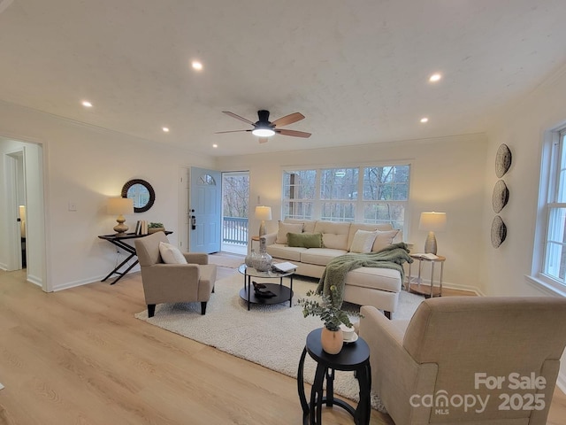 living room with ceiling fan, a healthy amount of sunlight, and light hardwood / wood-style floors