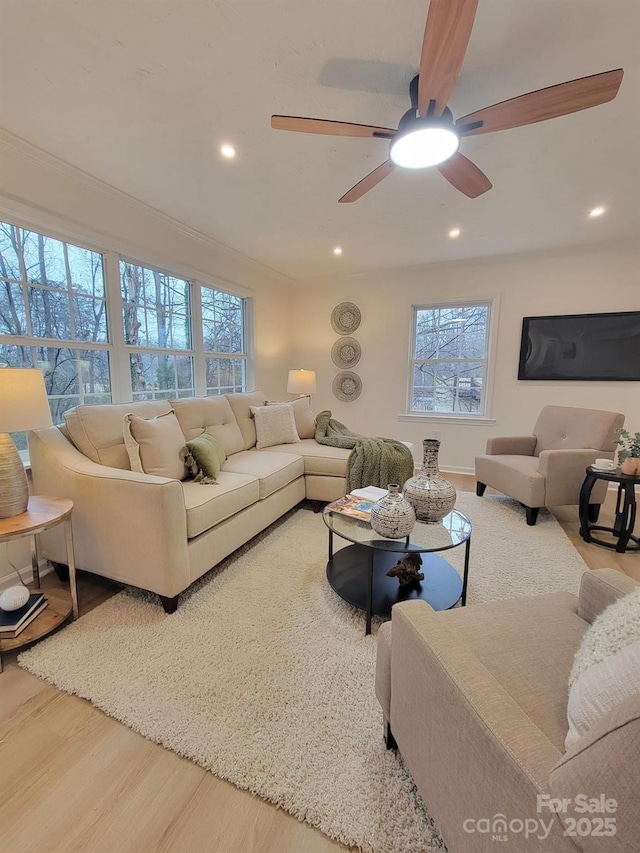 living room featuring wood-type flooring and ornamental molding