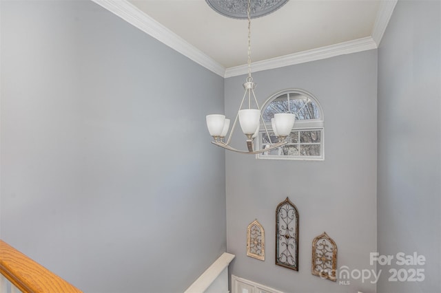 room details featuring ornamental molding and a notable chandelier