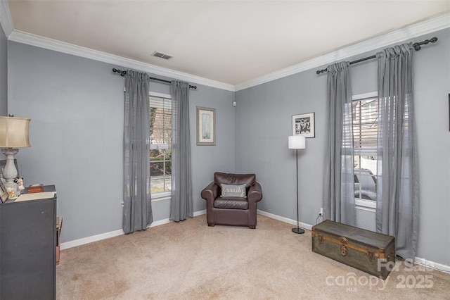 living area with ornamental molding, a wealth of natural light, and light colored carpet