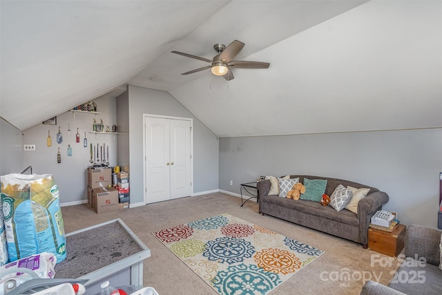 living area with lofted ceiling, ceiling fan, light colored carpet, and baseboards