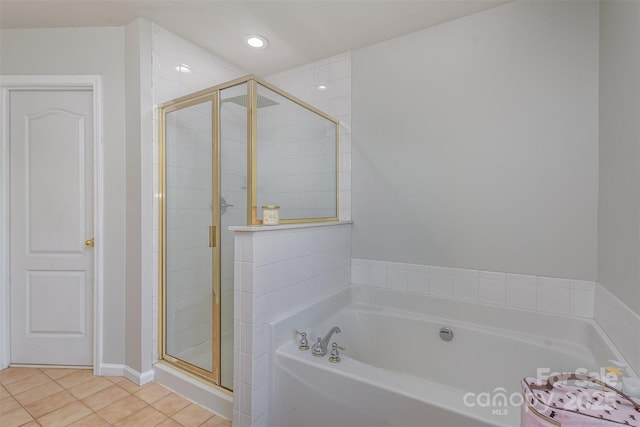 full bath with a stall shower, recessed lighting, a bath, and tile patterned floors